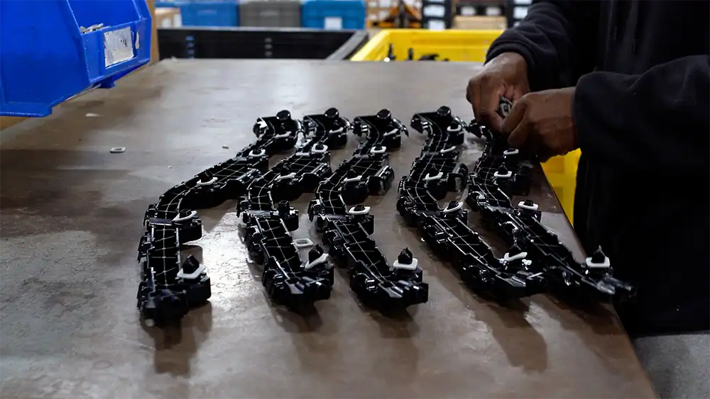 Engine timing chain components laid out on workbench in workshop.