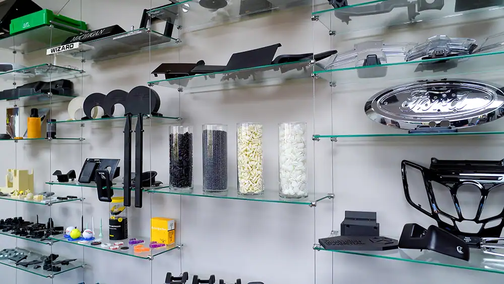 Automotive parts and accessories displayed on glass shelves at BMI-Corp staging site.