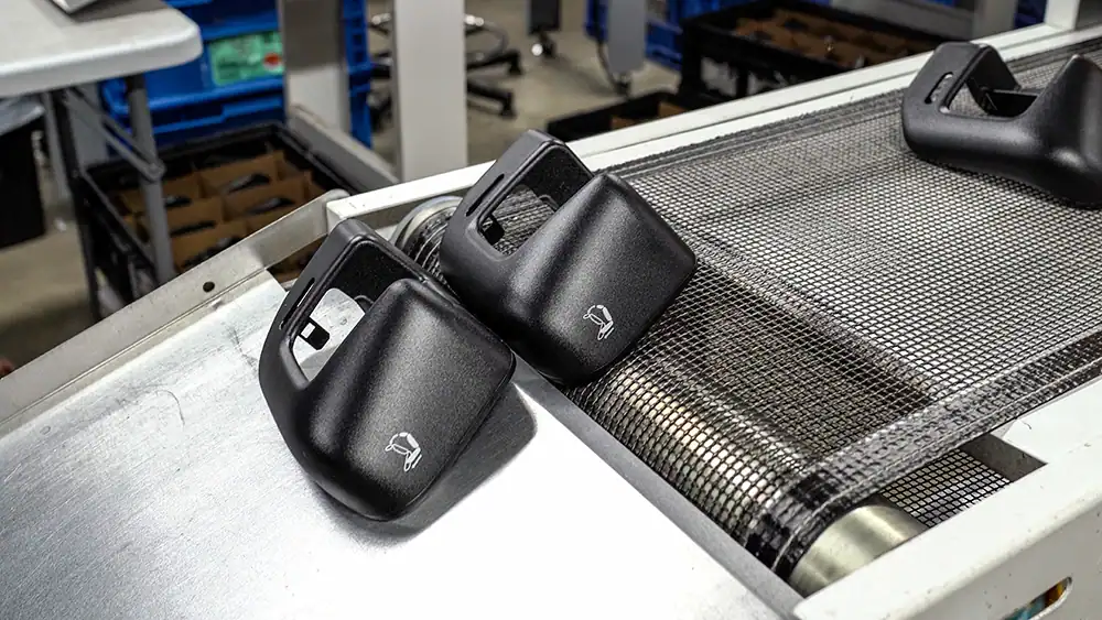 BMI-Corp staging site with conveyor and black handheld devices.