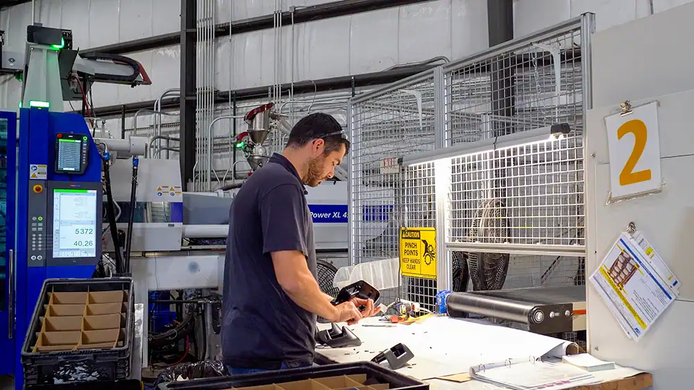 Worker operating machinery at BMI-Corp manufacturing plant.