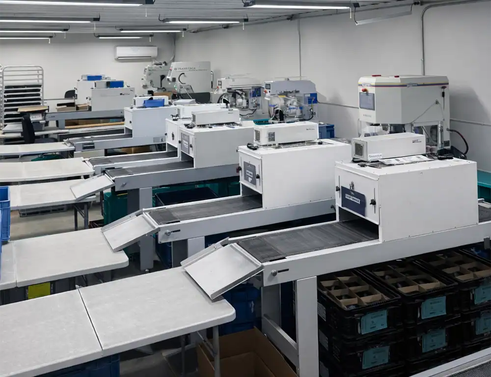 Modern industrial packaging machinery in a clean, organized factory setting.