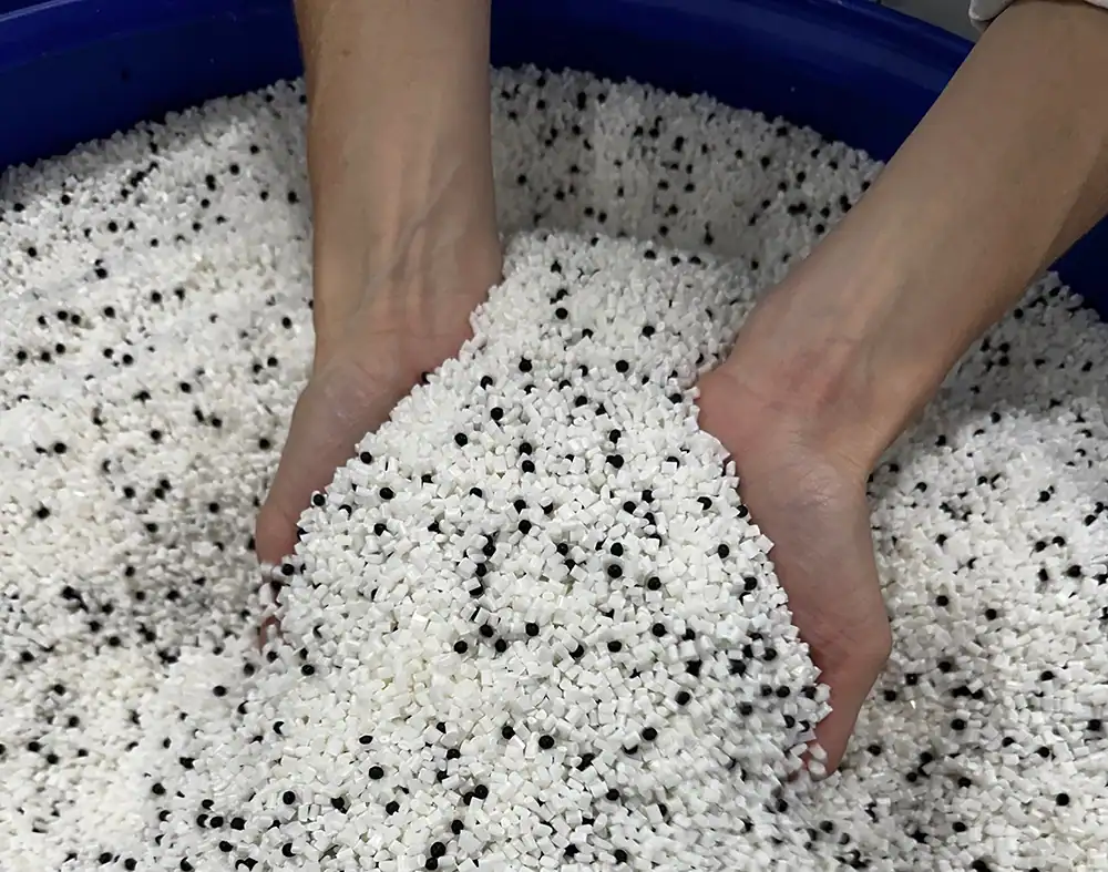 Foam beads being handled for product development in a manufacturing process.